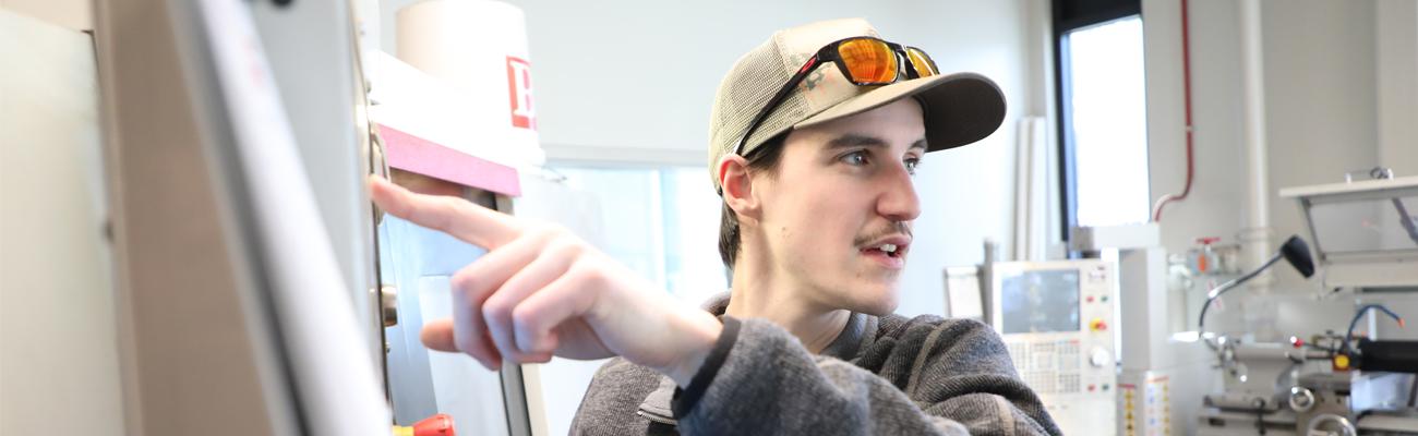 Student showing results on a lab machine